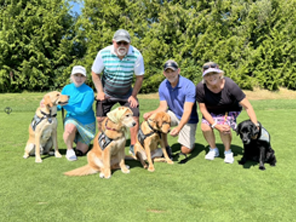 the team with dogs at a charity golf tournament