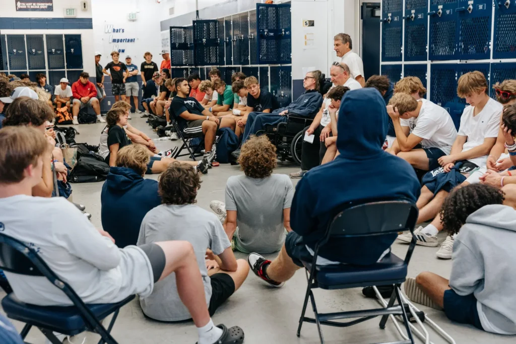Coach Young with team in Lake Oswego High School Locker Room, Fall 2025